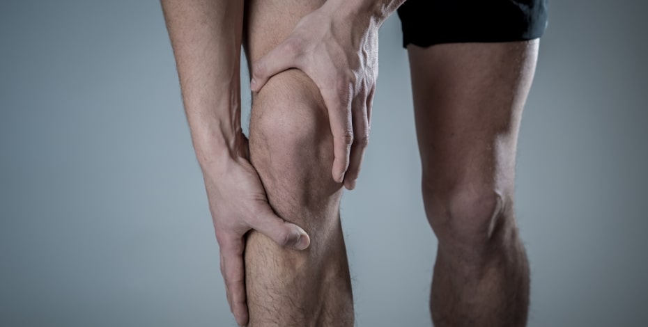 image of person holding their knee