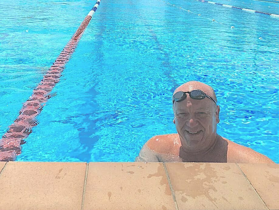 APA President Scott Willis standing at the end of a lap line in a swimming pool wearing goggles on his head